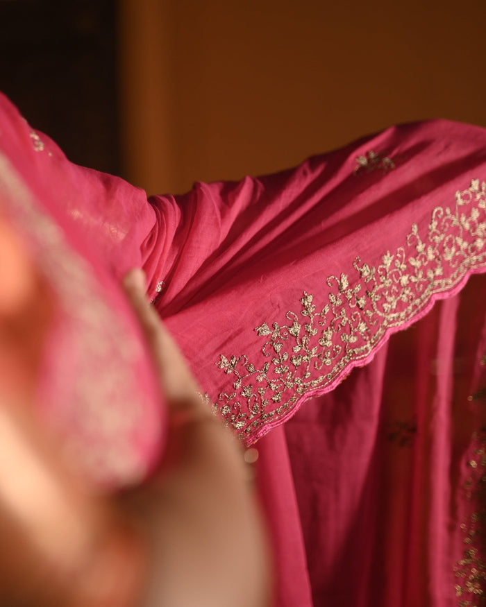 Fuchsia pink mulmul cotton saree with zari embroidery, soft airy elegance perfect for festive moments and summer styling.