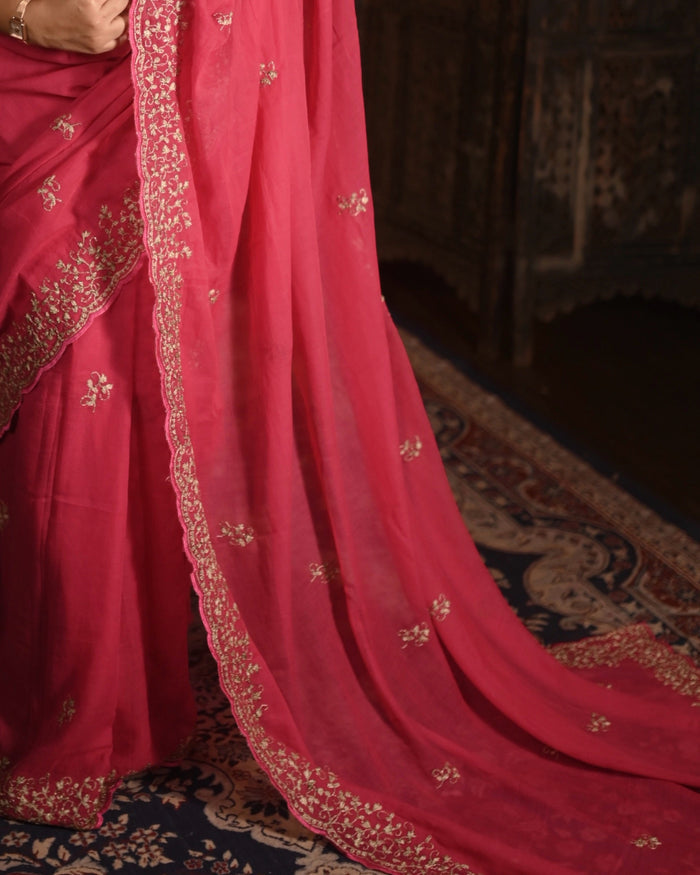 Lightweight fuchsia pink zari embroidered mulmul cotton saree, designed for festive wear with soft comfortable drape.