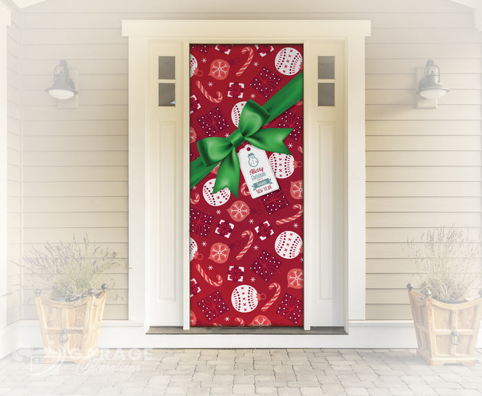 Decorative door with a red pattern featuring a green bow and white tag, set against a light wooden wall.