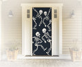 Decorative door with skeleton design in front of a house.