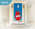 Decorative front door with Christmas-themed design featuring Snoopy and other Peanuts characters on top of a a red dog house wrapped up like a gift and sign that reads "Do not open until Christmas."