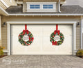 Garage door with Christmas wreaths and red ribbons on a house exterior.
