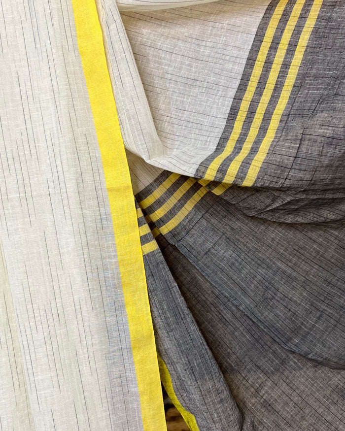 White yellow khaadi cotton saree featuring soft drape and timeless festive styling
