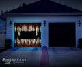 Garage door with a Halloween-themed design of vampire teeth, illuminated by blue lights.