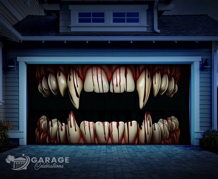 Halloween-themed garage door decoration with vampire teeth and blood, featuring the brand 'Garage Celebrations'.