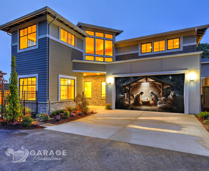 Modern house with a garage door featuring a nativity scene at dusk.
