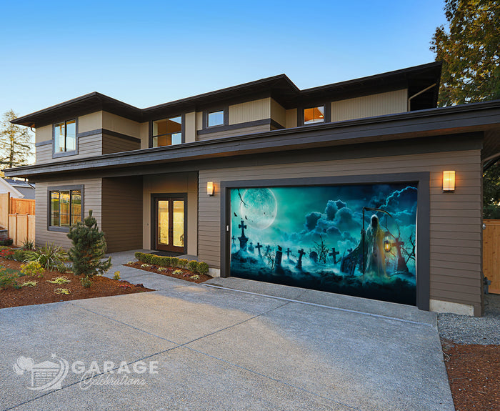 Modern home with a decorative garage door cover featuring a dark, spooky scene with a reaper, graveyard, grave, ghosts and a moonlit sky.