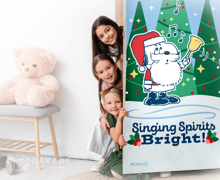 Three children peeking from behind a door with a Christmas-themed poster featuring Snoopy in a Santa hat and the text 'Singing Spirits Bright!'.